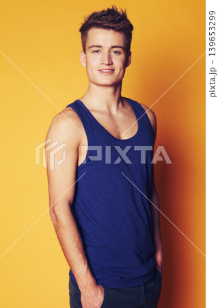 Fashion, smile and portrait of man in studio with trendy, cool or summer clothes on orange background. Face, style and male model with confidence, personality or casual, streetwear or outfit choice Fashion, smile and portrait of man in studio with trendy, cool or summer clothes on orange background. Face, style and male model with confidence, personality or casual, streetwear or outfit choice 139653299