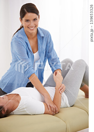 Physiotherapist, woman and elbow massage in clinic, helping and recovery from injury in portrait. People, physiotherapy and wellness in rehabilitation for health, stretching and arthritis with smile 139653326