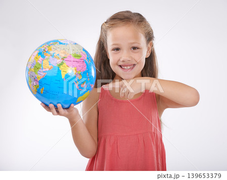 Child, pointing to globe in studio with world, planets and city for education, geography and portrait. Student, girl kid and travel map with smile for earth day support or ecology on white background Child, pointing to globe in studio with world, planets and city for education, geography and portrait. Student, girl kid and travel map with smile for earth day support or ecology on white background 139653379