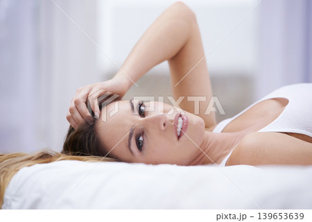 Woman, relax and portrait in bed on weekend, lazy and comfortable on morning at home. Female person, smiling and satisfaction while resting in bedroom, wake up and good mood on vacation or holiday Woman, relax and portrait in bed on weekend, lazy and comfortable on morning at home. Female person, smiling and satisfaction while resting in bedroom, wake up and good mood on vacation or holiday 139653639