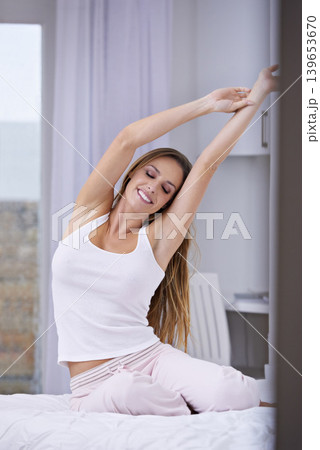Woman, wake up and stretching in bed on weekend, lazy and comfortable on morning at home. Female person, smile and satisfaction while resting in bedroom, relaxing and good mood on vacation or holiday Woman, wake up and stretching in bed on weekend, lazy and comfortable on morning at home. Female person, smile and satisfaction while resting in bedroom, relaxing and good mood on vacation or holiday 139653670