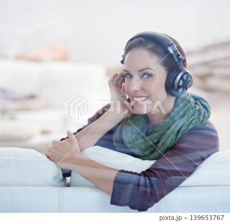 Portrait, smile and woman with music headphones on a sofa streaming, listening or chilling at home. Happy, face and female person in a living room with earphones for radio, audio or playlist track Portrait, smile and woman with music headphones on a sofa streaming, listening or chilling at home. Happy, face and female person in a living room with earphones for radio, audio or playlist track 139653767