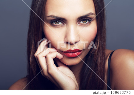 Makeup, portrait and woman in studio with confidence, pride and cosmetics on grey background. Glowing skin, beauty and female wellness model face with treatment, shine or red lipstick satisfaction Makeup, portrait and woman in studio with confidence, pride and cosmetics on grey background. Glowing skin, beauty and female wellness model face with treatment, shine or red lipstick satisfaction 139653776
