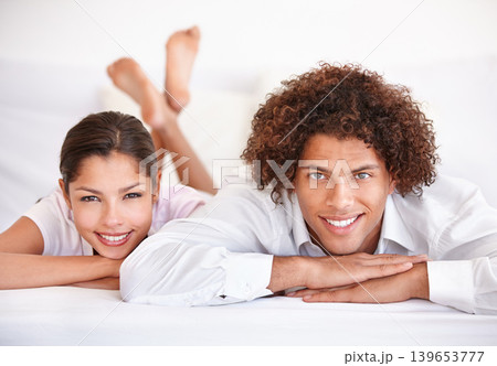 Couple, happy and portrait in bed on weekend, lazy and comfortable on morning at home. People, bonding and satisfaction while resting in bedroom, wake up and love on holiday or vacation to connect Couple, happy and portrait in bed on weekend, lazy and comfortable on morning at home. People, bonding and satisfaction while resting in bedroom, wake up and love on holiday or vacation to connect 139653777