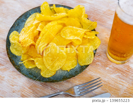 Appetizing chips with a glass of beer Appetizing chips with a glass of beer 139655223