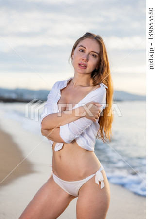 Summer vacation, travel and people concept - young woman on tropical beach over sea and sunset Summer vacation, travel and people concept - young woman on tropical beach over sea and sunset 139655580