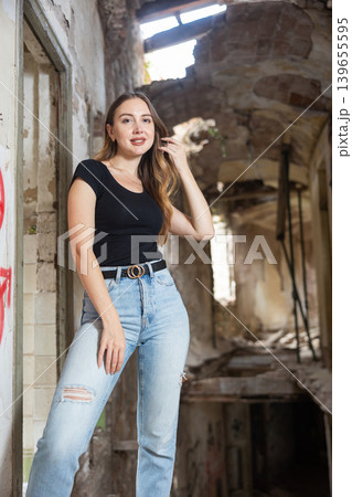 Portrait of smiling attractive woman in abandoned building Portrait of smiling attractive woman in abandoned building 139655595