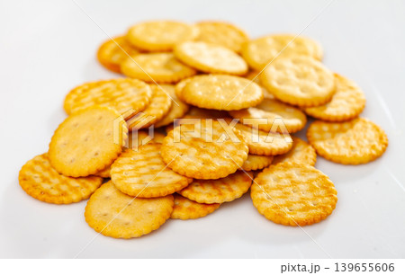 Heap of crispy salted crackers on white background Heap of crispy salted crackers on white background 139655606