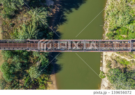 Aerial downward view of the Paterson railway bridge spanning the Hunter River in New South Wales Australia. Drone photograph captures the historic rail bridge crossing the winding river from above Aerial downward view of the Paterson railway bridge spanning the Hunter River in New South Wales Australia. Drone photograph captures the historic rail bridge crossing the winding river from above 139656072