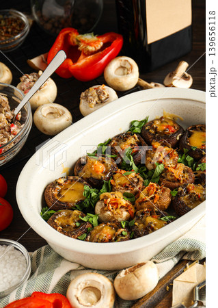 Mushrooms are baked with cheese and placed on a white dish Mushrooms are baked with cheese and placed on a white dish 139656118