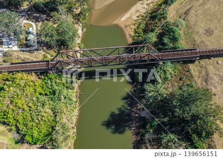 Aerial image of the Paterson railway bridge spanning the Hunter River in New South Wales Australia. Drone photograph captures the historic rail bridge crossing the winding river  139656151