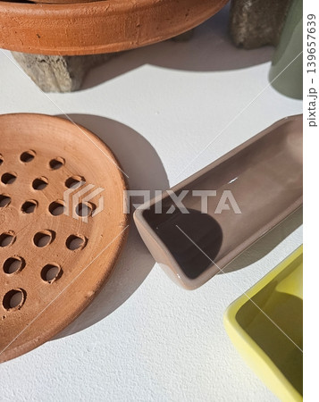 Minimalist Handmade Ceramic and Terracotta Tableware with Artistic Shadows 139657639
