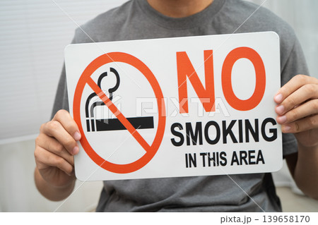 Male holding a no smoking sign. Male holding a no smoking sign. 139658170
