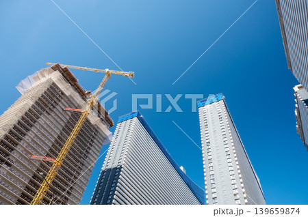 High-rise building under construction with tower crane, urban development and real estate concept High-rise building under construction with tower crane, urban development and real estate concept 139659874