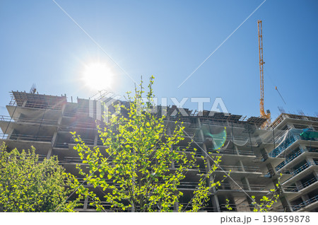 High-rise building under construction with tower crane, urban development and real estate concept High-rise building under construction with tower crane, urban development and real estate concept 139659878