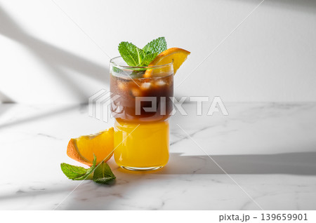 Cold bumble coffee with orange juice and ice on marble background 139659901
