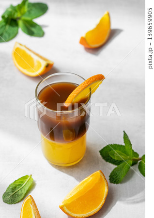Cold bumble coffee with orange juice and ice on light background Cold bumble coffee with orange juice and ice on light background 139659905