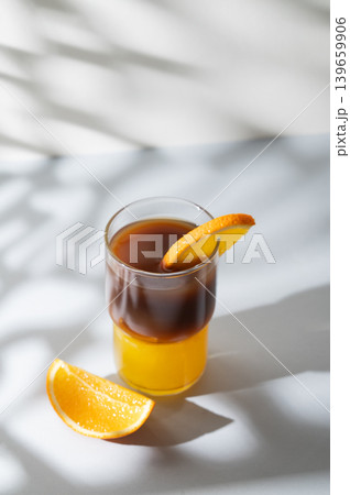 Cold bumble coffee with orange juice and ice on light background 139659906