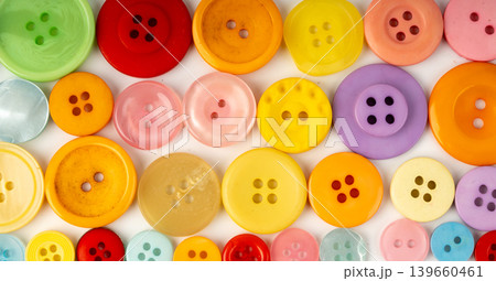 Multicolored sewing buttons. Plastic sew buttons of different colors and sizes Multicolored sewing buttons. Plastic sew buttons of different colors and sizes 139660461
