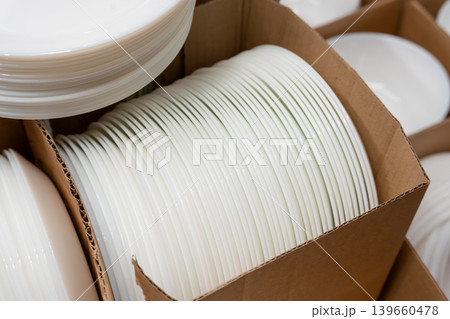 Boxes of white plates in crockery shop, dishware, tableware stack in store Boxes of white plates in crockery shop, dishware, tableware stack in store 139660478