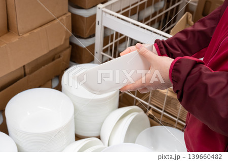 Boxes of white plates in crockery shop, dishware, tableware stack in store Boxes of white plates in crockery shop, dishware, tableware stack in store 139660482