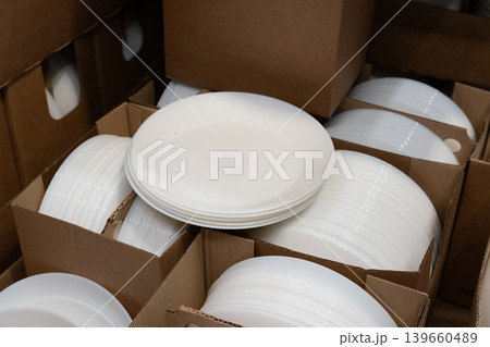 Boxes of white plates in crockery shop, dishware, tableware stack in store Boxes of white plates in crockery shop, dishware, tableware stack in store 139660489