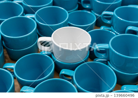 Blue cups and mugs in crockery shop, ceramic dishware, tableware stack in store Blue cups and mugs in crockery shop, ceramic dishware, tableware stack in store 139660496