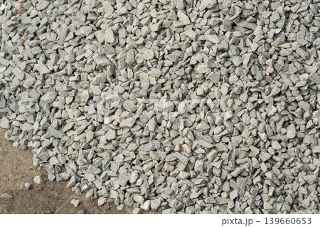 Construction gravel pattern, crushed grey stone textured background Construction gravel pattern, crushed grey stone textured background 139660653