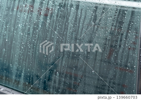 Drops on grey car surface after washing Drops on grey car surface after washing 139660703
