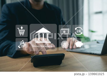 Businessman using digital money management interface on smartphone and laptop with online banking, finance technology, investment planning, cashflow analysis and fintech icons in office Businessman using digital money management interface on smartphone and laptop with online banking, finance technology, investment planning, cashflow analysis and fintech icons in office 139661025