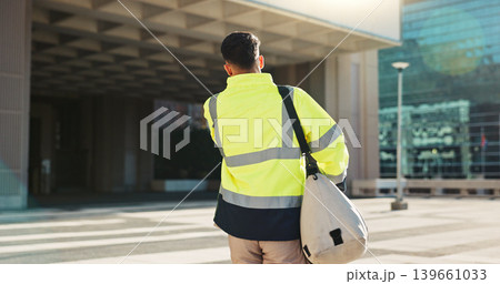 Man, back and architect walking in city for construction, maintenance or building at outdoor site. Rear view of male person, engineer or contractor carrying bag for project, architecture or plan 139661033