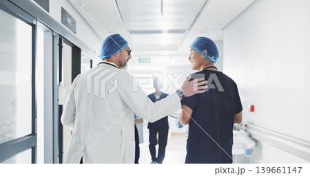 Doctor, nurse and talk while walk in hospital with advice, consult or communication with medical team. People, discuss or coaching for patient care, treatment and wellness after surgery with joke Doctor, nurse and talk while walk in hospital with advice, consult or communication with medical team. People, discuss or coaching for patient care, treatment and wellness after surgery with joke 139661147
