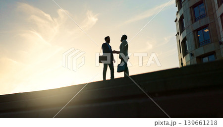 Business people, handshake and city silhouette for partnership, outdoor introduction and travel meeting. Corporate clients or men shaking hands for welcome, hello and agreement or career opportunity Business people, handshake and city silhouette for partnership, outdoor introduction and travel meeting. Corporate clients or men shaking hands for welcome, hello and agreement or career opportunity 139661218