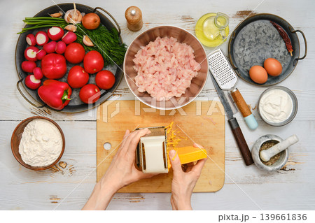 Preparing ingredients for a meal with fish, vegetables, herbs, and spices in the kitchen Preparing ingredients for a meal with fish, vegetables, herbs, and spices in the kitchen 139661836