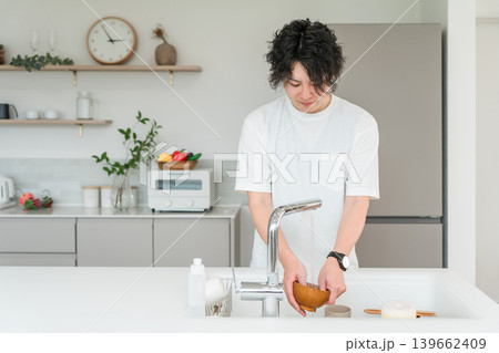 キッチンで洗い物をする若いアジア人男性 139662409