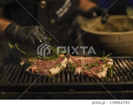 fresh beef steaks cooking on the grill 139662593