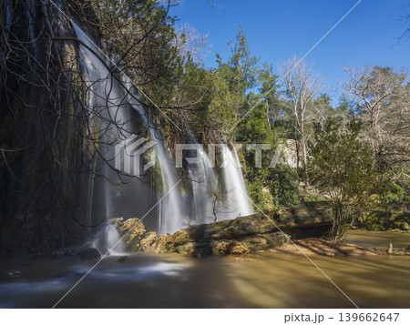 stunning natural waterfall cascading over rocks in a forest stunning natural waterfall cascading over rocks in a forest 139662647
