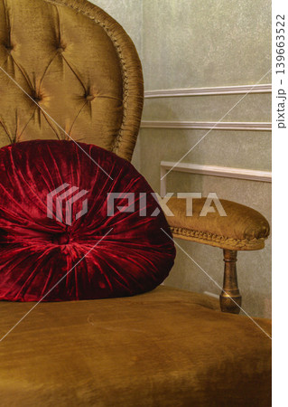 Old fashioned armchair with velvet pillow. Classic living room design. Cozy home style. Classic home design. Retro chair with red cushion. Old fashioned couch. Elegant interior design. Old fashioned armchair with velvet pillow. Classic living room design. Cozy home style. Classic home design. Retro chair with red cushion. Old fashioned couch. Elegant interior design. 139663522