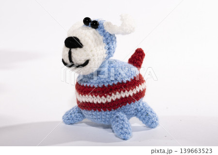 Knitted woolen dog on a white background Knitted woolen dog on a white background 139663523