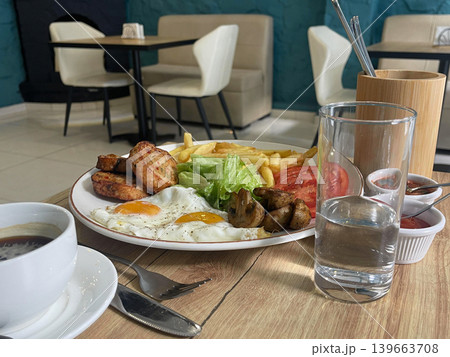 English breakfast with fried eggs, French fries, and meatloaf at English breakfast with fried eggs, French fries, and meatloaf at 139663708