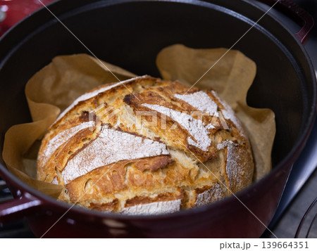 Homemade sourdough bread baking in Dutch oven Homemade sourdough bread baking in Dutch oven 139664351