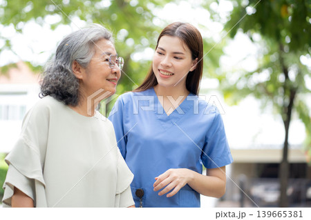 Asian female caregiver assistance senior patient with walker for physical rehabilitation and therapy Asian female caregiver assistance senior patient with walker for physical rehabilitation and therapy 139665381