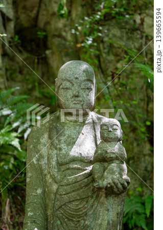 Jizo Bosatsu statue holding baby at Mitaki-Dera in Hiroshima Jizo Bosatsu statue holding baby at Mitaki-Dera in Hiroshima 139665594