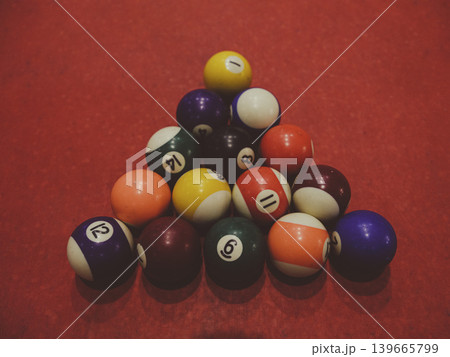 billiard balls on red pool table 139665799