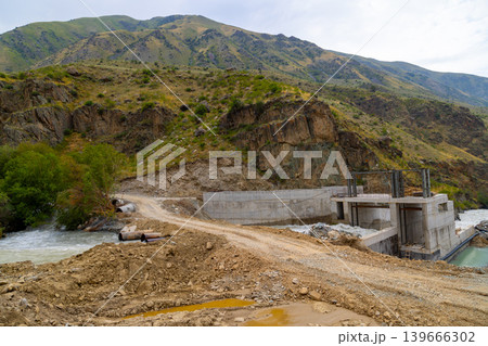 Concrete hydroelectric dam construction site in mountainous area 139666302