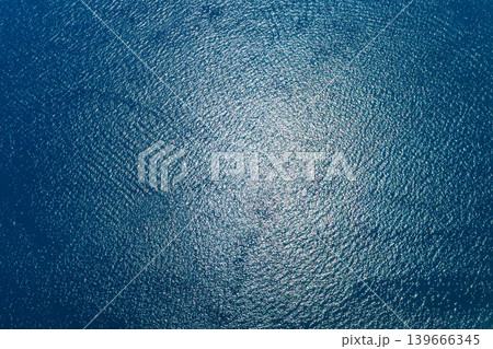 Aerial view of rippling blue water with sun reflections 139666345