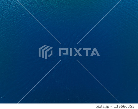 Aerial view of calm deep blue water surface with ripples Aerial view of calm deep blue water surface with ripples 139666353