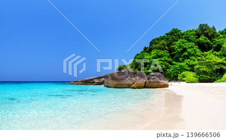 Beautiful tropical beach with white sand, turquoise sea, coastal rocks, and lush green vegetation on the Similan Islands, near Phuket in Thailand. Beautiful tropical beach with white sand, turquoise sea, coastal rocks, and lush green vegetation on the Similan Islands, near Phuket in Thailand. 139666506