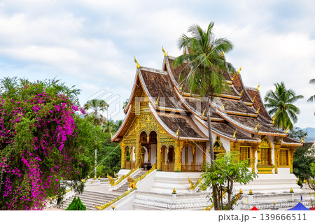 Beautiful historic Wat Xieng Thong temple in Luang Prabang, Laos. Iconic Buddhist architecture and UNESCO heritage landmark surrounded by tropical gardens. Beautiful historic Wat Xieng Thong temple in Luang Prabang, Laos. Iconic Buddhist architecture and UNESCO heritage landmark surrounded by tropical gardens. 139666511