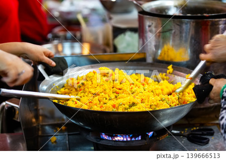 Close-up of cooking traditional Vietnamese rice meal in a large wok in Ho Chi Minh City, Vietnam. 139666513